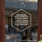 Custom open hours decal applied on wooden glass door, business storefront vinyl lettering, personalized store hours sticker by TheRetractableBanner.Shop