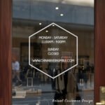 Custom open hours decal applied on wooden glass door, business storefront vinyl lettering, personalized store hours sticker by TheRetractableBanner.Shop