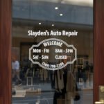 Custom open hours decal applied on wooden glass door, business storefront vinyl lettering, personalized store hours sticker by TheRetractableBanner.Shop