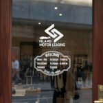 Custom open hours decal applied on wooden glass door, business storefront vinyl lettering, personalized store hours sticker by TheRetractableBanner.Shop