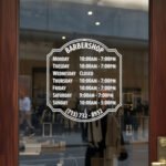 Custom open hours decal applied on wooden glass door, business storefront vinyl lettering, personalized store hours sticker by TheRetractableBanner.Shop
