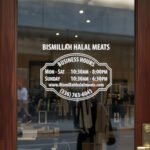 Custom open hours decal applied on wooden glass door, business storefront vinyl lettering, personalized store hours sticker by TheRetractableBanner.Shop