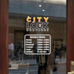 Custom open hours decal applied on wooden glass door, business storefront vinyl lettering, personalized store hours sticker by TheRetractableBanner.Shop