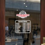 Custom open hours decal applied on wooden glass door, business storefront vinyl lettering, personalized store hours sticker by TheRetractableBanner.Shop