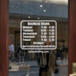Custom open hours decal applied on wooden glass door, business storefront vinyl lettering, personalized store hours sticker by TheRetractableBanner.Shop