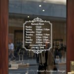 Custom open hours decal applied on wooden glass door, business storefront vinyl lettering, personalized store hours sticker by TheRetractableBanner.Shop