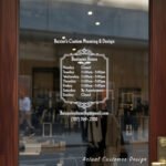 Custom open hours decal applied on wooden glass door, business storefront vinyl lettering, personalized store hours sticker by TheRetractableBanner.Shop