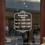 Custom open hours decal applied on wooden glass door, business storefront vinyl lettering, personalized store hours sticker by TheRetractableBanner.Shop