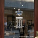 Custom open hours decal applied on wooden glass door, business storefront vinyl lettering, personalized store hours sticker by TheRetractableBanner.Shop