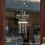 Custom open hours decal applied on wooden glass door, business storefront vinyl lettering, personalized store hours sticker by TheRetractableBanner.Shop