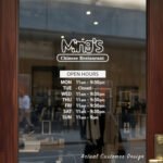 Custom open hours decal applied on wooden glass door, business storefront vinyl lettering, personalized store hours sticker by TheRetractableBanner.Shop