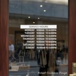 Custom open hours decal applied on wooden glass door, business storefront vinyl lettering, personalized store hours sticker by TheRetractableBanner.Shop