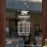 Custom open hours decal applied on wooden glass door, business storefront vinyl lettering, personalized store hours sticker by TheRetractableBanner.Shop
