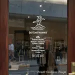 Custom open hours decal applied on wooden glass door, business storefront vinyl lettering, personalized store hours sticker by TheRetractableBanner.Shop