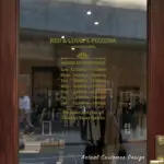 Custom open hours decal applied on wooden glass door, business storefront vinyl lettering, personalized store hours sticker by TheRetractableBanner.Shop