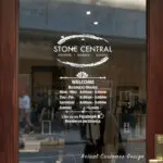 Custom open hours decal applied on wooden glass door, business storefront vinyl lettering, personalized store hours sticker by TheRetractableBanner.Shop