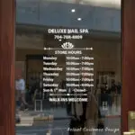 Custom open hours decal applied on wooden glass door, business storefront vinyl lettering, personalized store hours sticker by TheRetractableBanner.Shop