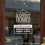 Custom open hours decal applied on wooden glass door, business storefront vinyl lettering, personalized store hours sticker by TheRetractableBanner.Shop