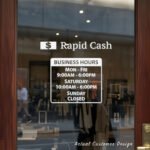 Custom open hours decal applied on wooden glass door, business storefront vinyl lettering, personalized store hours sticker by TheRetractableBanner.Shop
