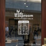 Custom open hours decal applied on wooden glass door, business storefront vinyl lettering, personalized store hours sticker by TheRetractableBanner.Shop